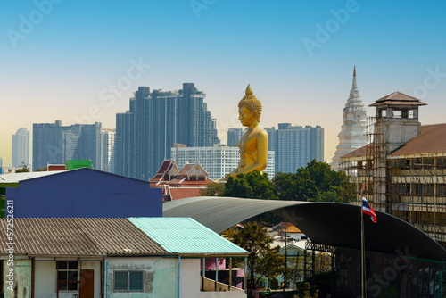 Photography Huge Buddha image that appears between the buildings
