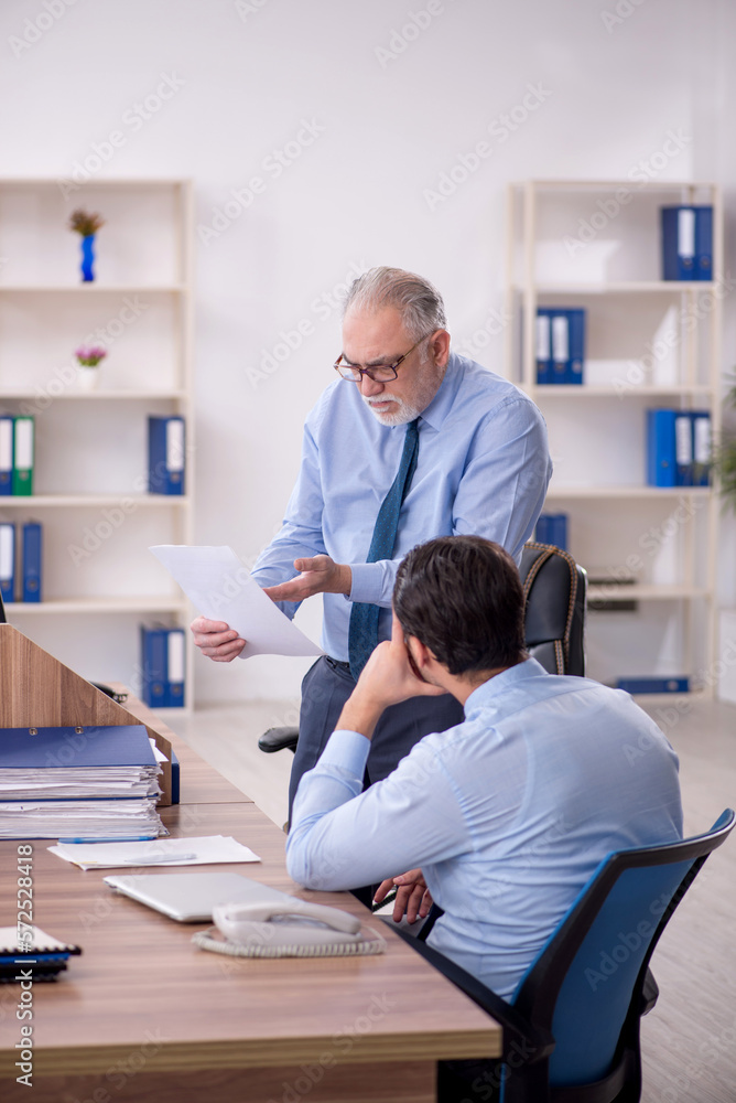 Two male colleagues working in the office