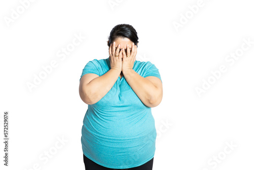 Young overweight indian woman covering eyes with hands feeling embarrassed, Plus size asian female with sad and fear expression. Body Shaming and obesity concept.