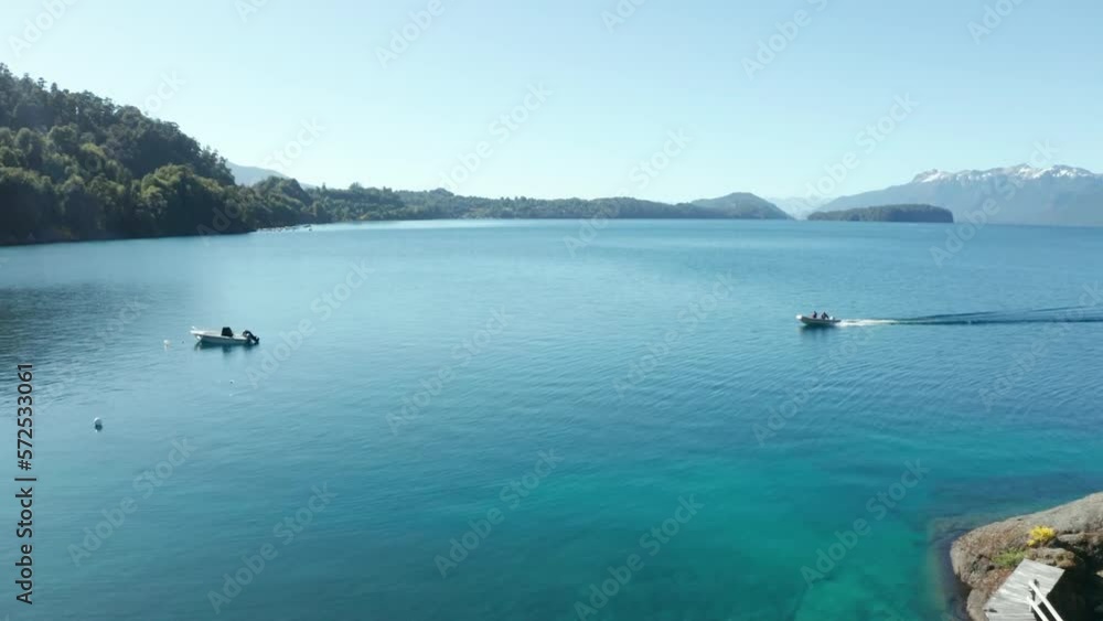 AERIAL - Motorboat in Puerto Arauco, Villa Angostura, Neuquen, Argentina, forward reveal AERIAL - Motorboat in Puerto Arauco, Villa Angostura, Neuquen, Argentina, forward reveal