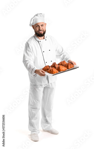 Male baker with tray of tas...