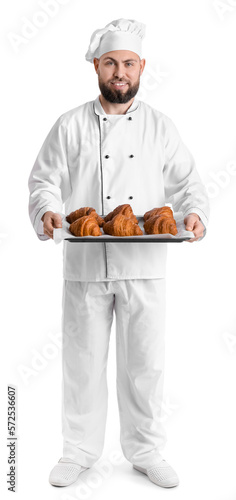 Male baker with tray of tas...