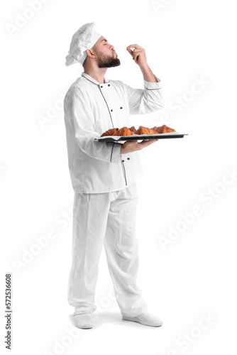 Male baker with tray of tas...