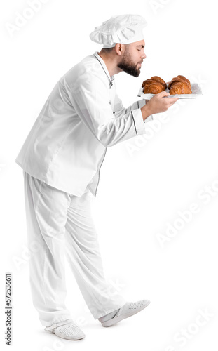 Male baker with tray of tas...