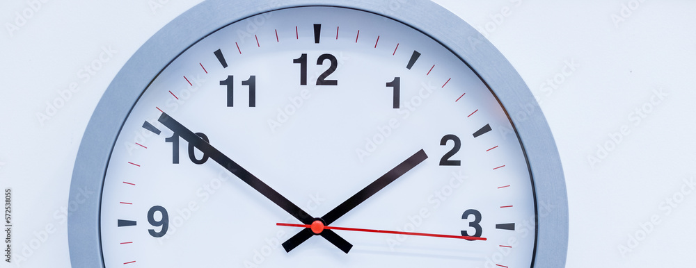 part of silver big analogue plain wall clock on trendy pastel blue background. copy space, time management concept and opening or closing hours.time management and business concept part of silver big analogue plain wall clock on trendy pastel blue background. copy space, time management concept and opening or closing hours.time management and business concept