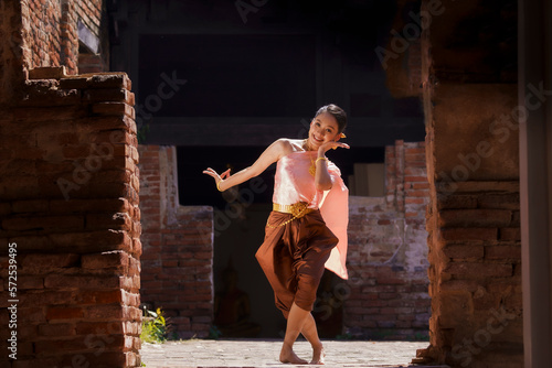 A beautiful lady  in Thai traditional costume shows traditional basic Thai dance.