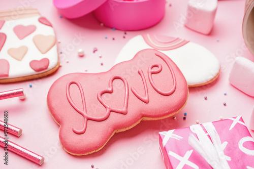 Tasty cookies for Valentine's Day celebration on pink background, closeup