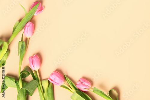 Fototapeta Naklejka Na Ścianę i Meble -  Frame made of beautiful tulip flowers on beige background