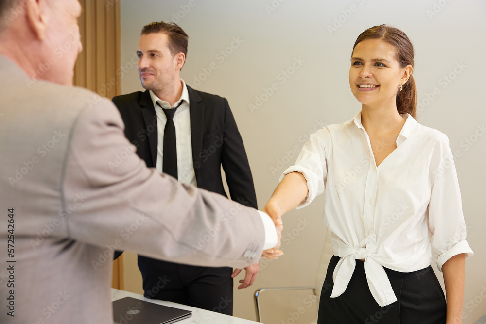 businesswoman shaking hands from success at work or project in conference room