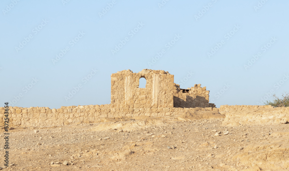 The remains  of internal buildings in the rays of the rising sun in the ruins of the fortress of Masada - is a fortress built by Herod the Great on a cliff-top off the coast of the Dead Sea, Israel