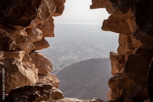 View from the gap in the fortress wall to the Dead Sea in the ruins of the fortress of Masada - is a fortress built by Herod the Great on a cliff-top off the coast of the Dead Sea, in southern Israel