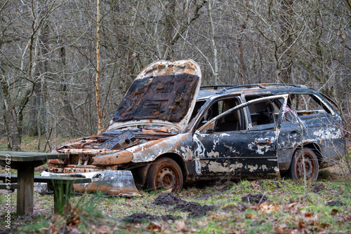 Burnt down car in the woods
