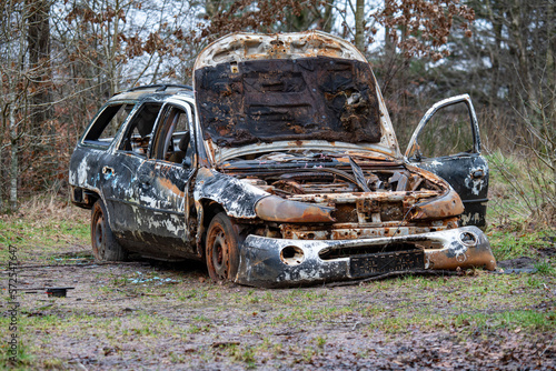 Burnt down car in the forest