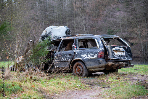 Burnt down car in the forest