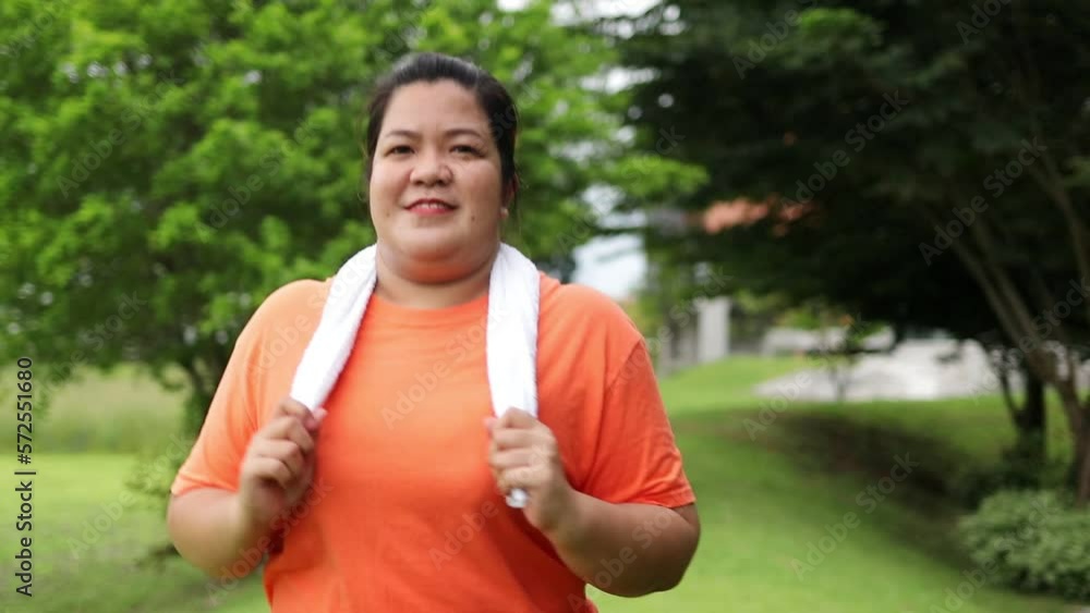 Asian fat woman smiling happy running outdoor exercise to lose weight Make your body healthy. health care sports concept Asian fat woman smiling happy running outdoor exercise to lose weight Make your body healthy. health care sports concept
