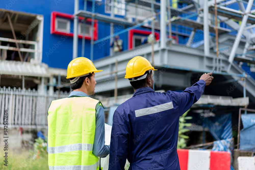 African American Technician, Asian Engineer use blueprint to inspect construction. Group of Multi-Ethnic Blue-collar worker. Teamwork of Architect review plans at construction site.
African American Technician, Asian Engineer use blueprint to inspect construction. Group of Multi-Ethnic Blue-collar worker. Teamwork of Architect review plans at construction site.