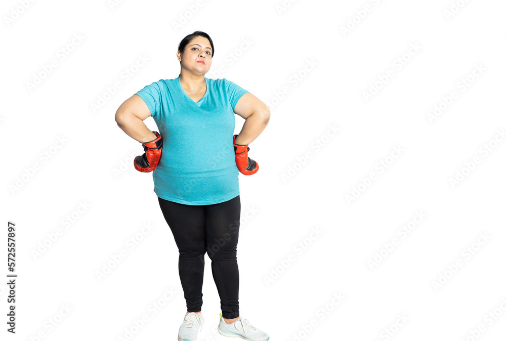 Confident overweight indian woman wearing boxing gloves standing isolated over white studio background, Asian sporty fat lady. Copy space.