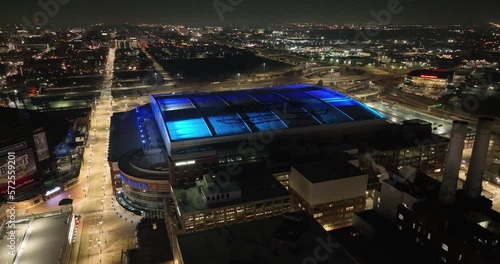 Ford Field, home of the Detroit Lions in Detroit, Michigan at night with drone video flying over. photo