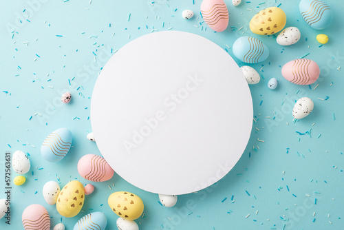 Easter decor concept. Top view photo of ordered composition white circle yellow blue pink easter eggs and sprinkles on isolated pastel blue background with empty space