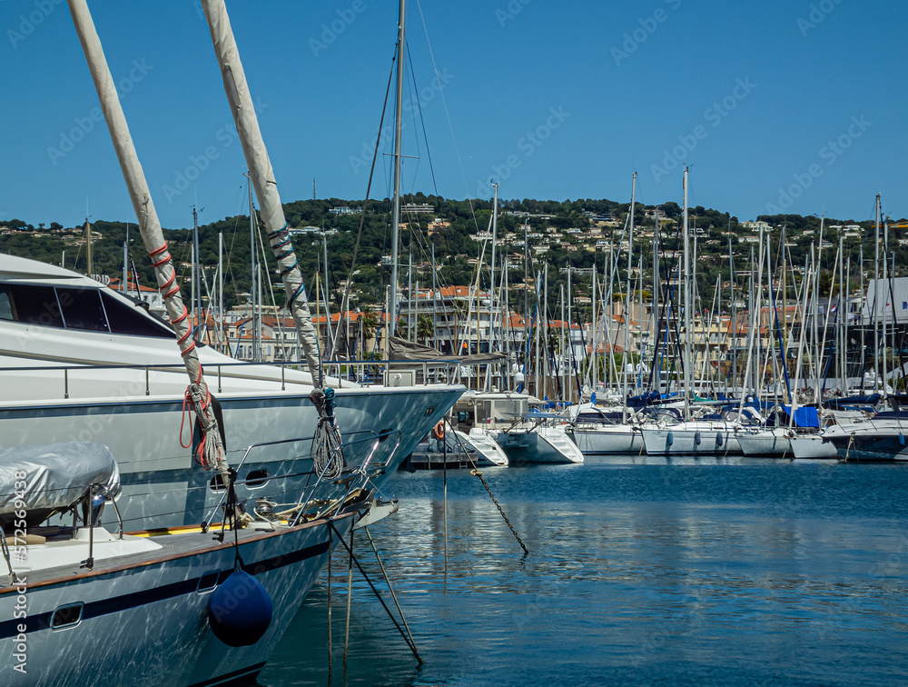 The yachts at the pier with a clear summer sunny morning. and view of city quarters
