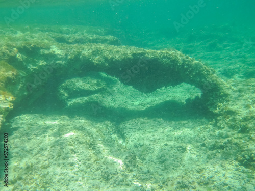 Arco de piedra natural formado bajo el agua, fotografía submarina. Fondo marino de la costa del mar Jónico, costa de Pizzo en Italia.