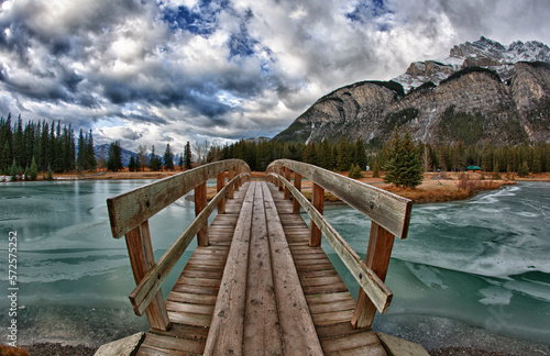 View across bridge over river to mountains photo