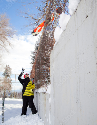 Snowboarder throwing board photo