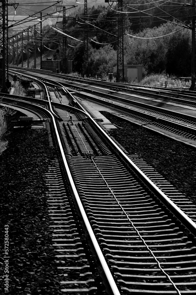 Railway track on main line between Cologne and Frankfurt near Montabaur Germany. High speed railroad with concrete sleepers, steel rails and switches. Black and white greyscale with high contrast.