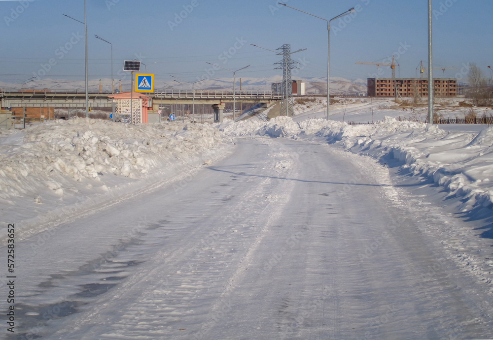 One of the city streets. Snowy road. City outskirts. Ust-Kamenogorsk (kazakhstan) One of the city streets. Snowy road. City outskirts. Ust-Kamenogorsk (kazakhstan)