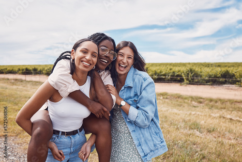 Friends, portrait and piggyback of women on holiday, vacation or trip outdoors. Group freedom, comic adventure and happy girls laughing at joke, having fun or enjoying quality time together in nature #572584806