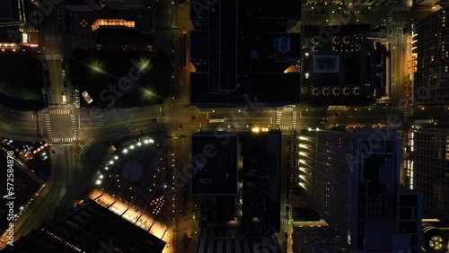 Wallpaper Mural Top down aerial shot of large American city at night. Light traffic and city bus driving on streets below. High drone shot at dusk. Torontodigital.ca