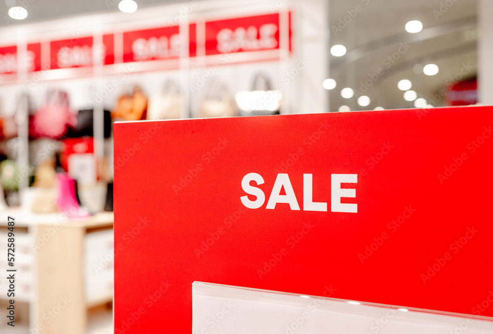 Sale season offers sign in commercial shopping center