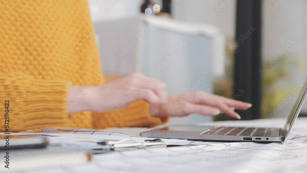Asian Business woman using calculator and laptop for doing math finance on an office desk, tax, report, accounting, statistics, and analytical research concept Asian Business woman using calculator and laptop for doing math finance on an office desk, tax, report, accounting, statistics, and analytical research concept
