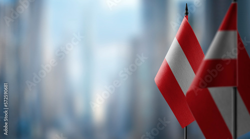 Obraz na plátně A small Austria flag on an abstract blurry background
