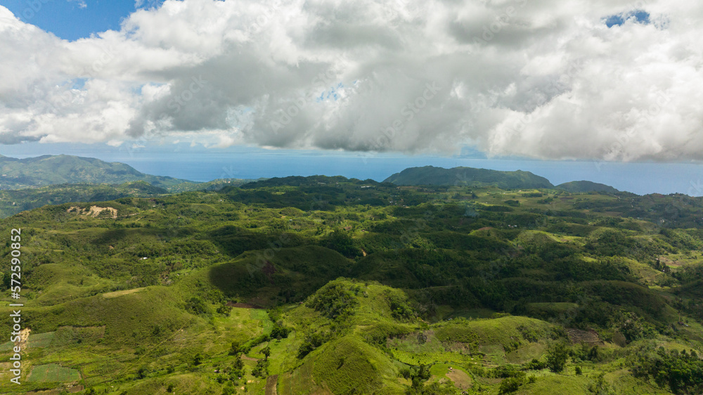 Aerial view of agricultural land among hills and mountains in a mountainous province. Libo hills. Cebu island, Philippines.