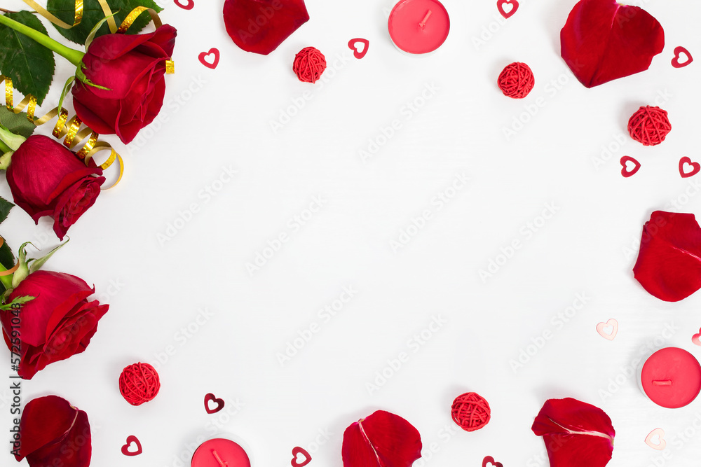Composition of red roses, rose petals, sequin hearts, candles, gold ribbons on white background. Content for Birthday, Valentines Day, Womens day, Mothers day. Flat lay, top view, close up, copy space