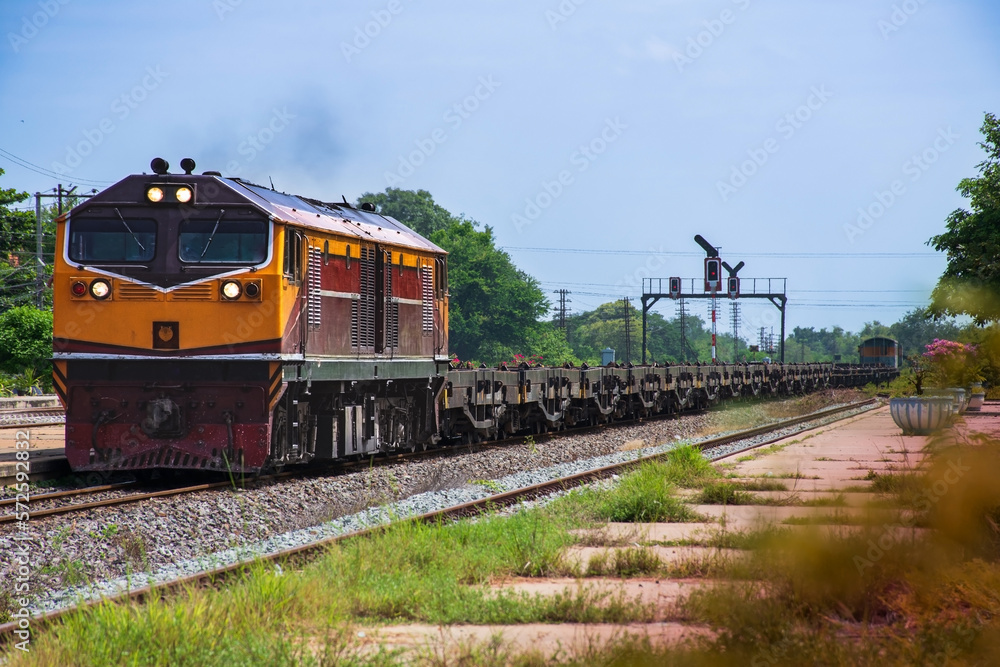 Obraz premium Freight train by diesel locomotive passed the railway station.