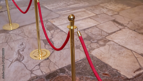 Gold-plated racks with velvet red ropes. Fencing zone