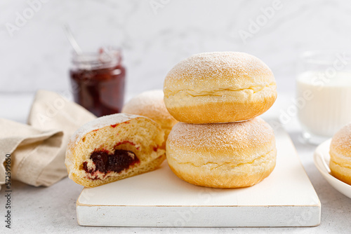 Berliner donut. Traditional german donut with raspberry jam, dusted with icing sugar
