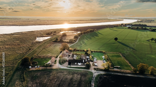 Sunset over the Humber and a farm and fields over Broomfleet, Near Hull, United Kingdom.