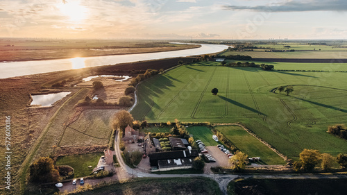 Sunset over the Humber and a farm and fields over Broomfleet, Near Hull, United Kingdom.
