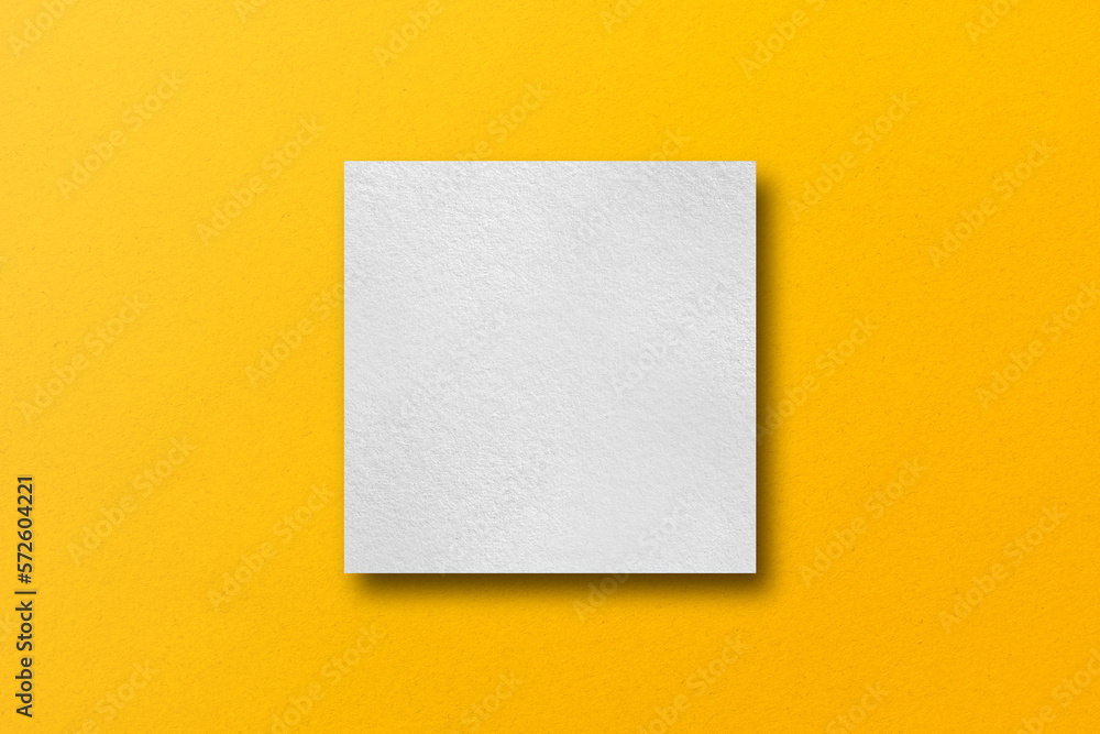 paper cut into square shapes with light and shadow placed on a yellow paper background paper cut into square shapes with light and shadow placed on a yellow paper background