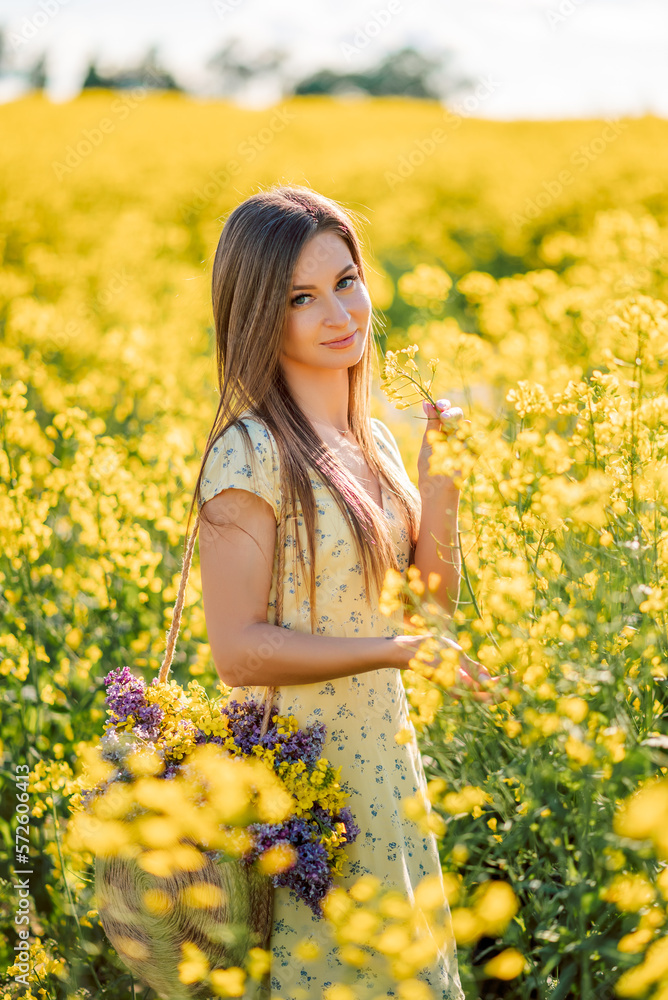 Portrait of a beautiful girl in yellow rapeseed flowers Portrait of a beautiful girl in yellow rapeseed flowers