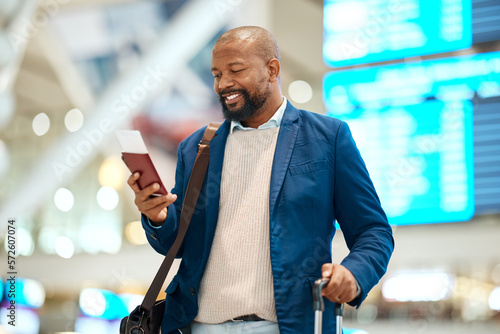 Black man in airport with passport, ticket and smile, travelling to foreign country for business trip. Visa, travel and happy businessman waiting for flight time to international destination for work photo