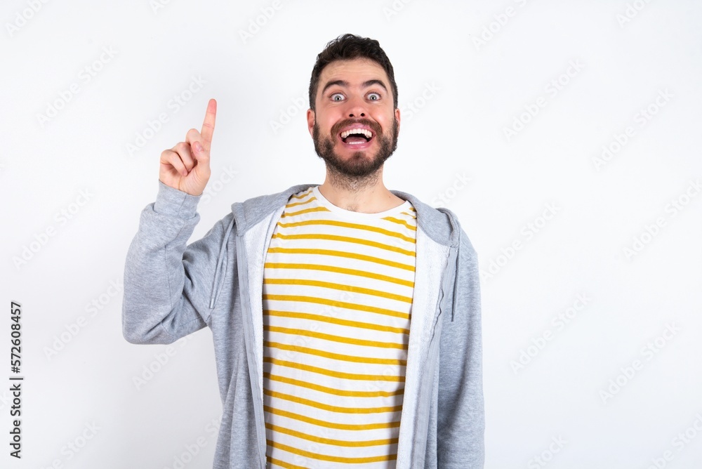 caucasian man wearing casual sportswear over white wall pointing finger up and looking inspired by genius thought, showing good idea sign, having clever solution in mind caucasian man wearing casual sportswear over white wall pointing finger up and looking inspired by genius thought, showing good idea sign, having clever solution in mind