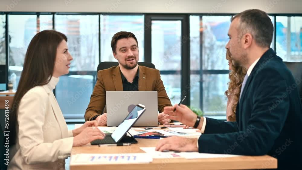 Business meeting in an office, workers discussing business affairs. Gadgets and papers on the table. Slow motion Business meeting in an office, workers discussing business affairs. Gadgets and papers on the table. Slow motion
