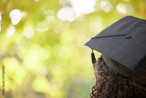 Graduation cap, trees and back of woman outdoor for education achievement, success and goals with bokeh. Nature, mockup space and female university or college graduate planning future for motivation.