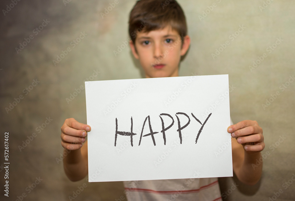 A child holding with his arms a happy message A child holding with his arms a happy message