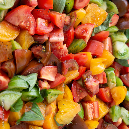 bowl with various fresh vegetables in different colors photo