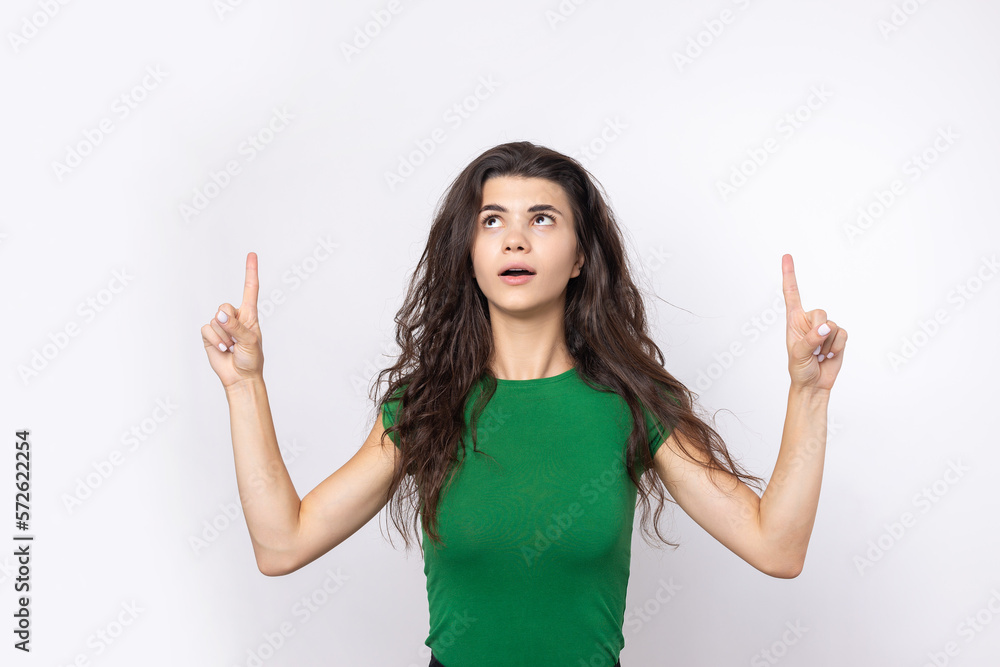 Happy young caucasian female in a shirt pointing fingers away Happy young caucasian female in a shirt pointing fingers away